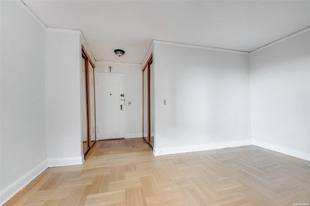 corridor with crown molding and light parquet floors