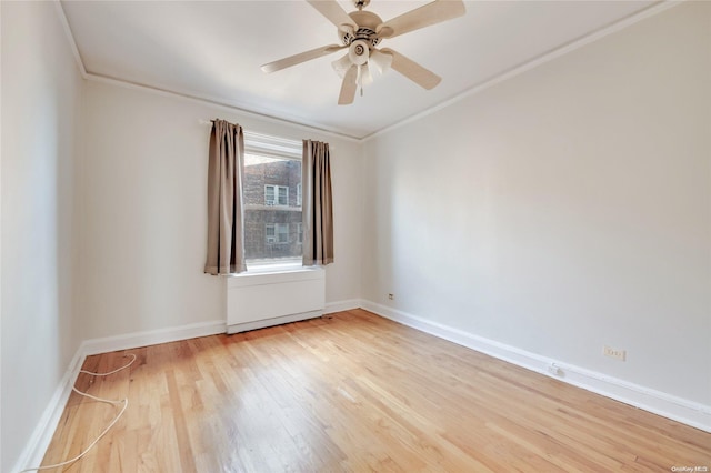 unfurnished room with ceiling fan, light wood-type flooring, and ornamental molding