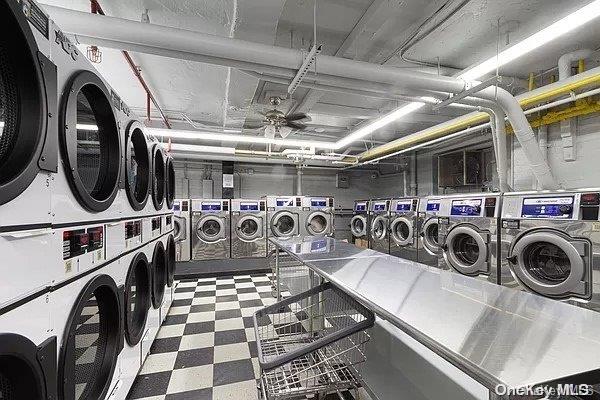 laundry area featuring washing machine and dryer, ceiling fan, and stacked washing maching and dryer