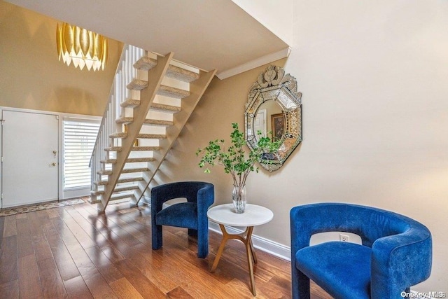 sitting room featuring wood-type flooring and ornamental molding