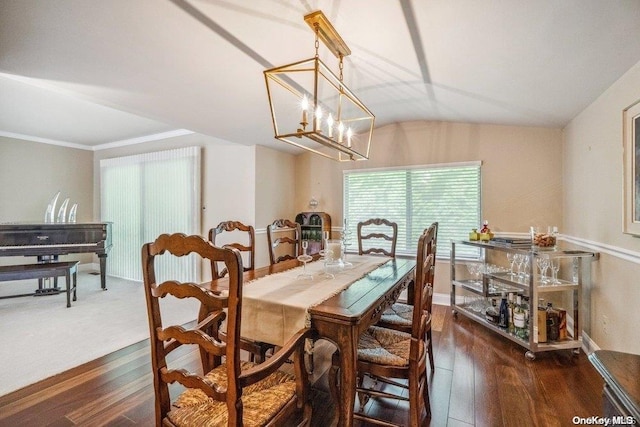 dining space with vaulted ceiling, dark hardwood / wood-style floors, and a notable chandelier