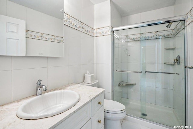 bathroom with backsplash, walk in shower, vanity, tile walls, and toilet