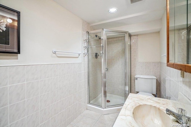 bathroom featuring walk in shower, tile walls, and sink