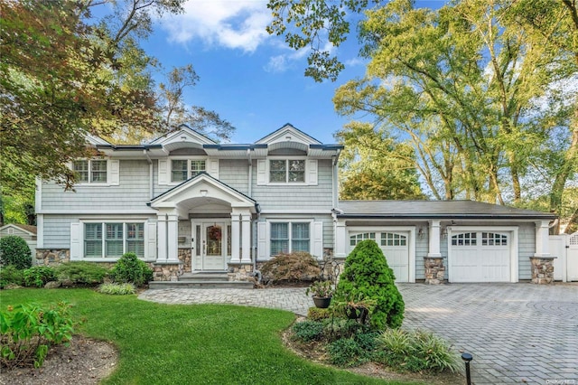 view of front of house with a garage and a front yard