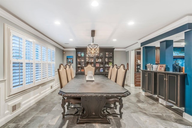 dining space with ornamental molding