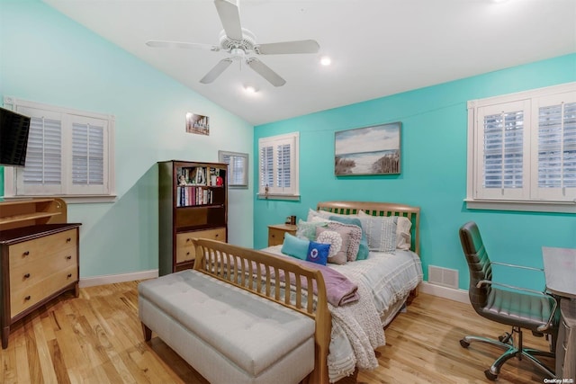 bedroom with light hardwood / wood-style floors, ceiling fan, and lofted ceiling