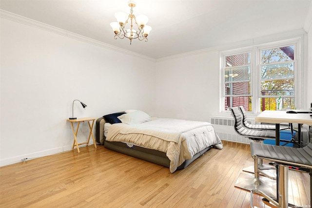 bedroom with radiator heating unit, ornamental molding, light hardwood / wood-style floors, and an inviting chandelier