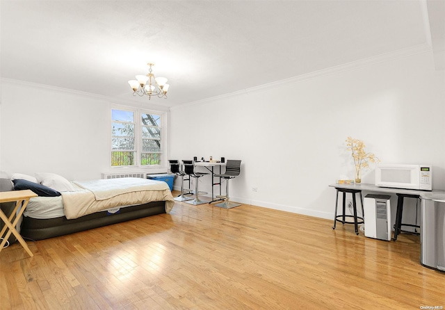 bedroom with crown molding, radiator heating unit, light hardwood / wood-style floors, and an inviting chandelier