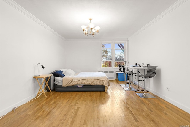 bedroom with light hardwood / wood-style floors, ornamental molding, radiator, and a chandelier