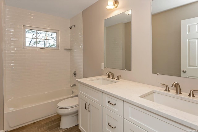 full bathroom with vanity, toilet, and tiled shower / bath