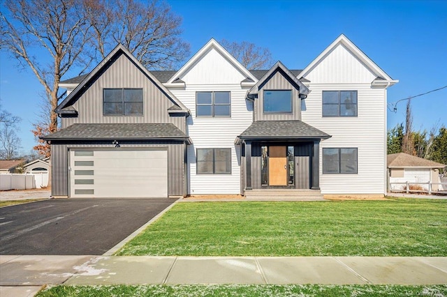 view of front of house featuring a garage and a front lawn