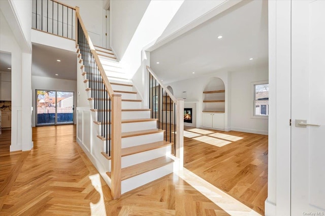 stairway featuring parquet floors