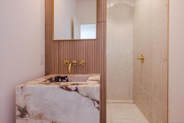 bathroom with wood walls and sink