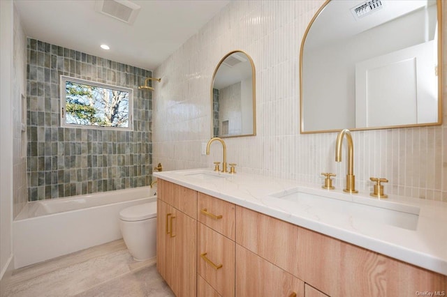 full bathroom with shower / bathing tub combination, toilet, decorative backsplash, vanity, and tile walls