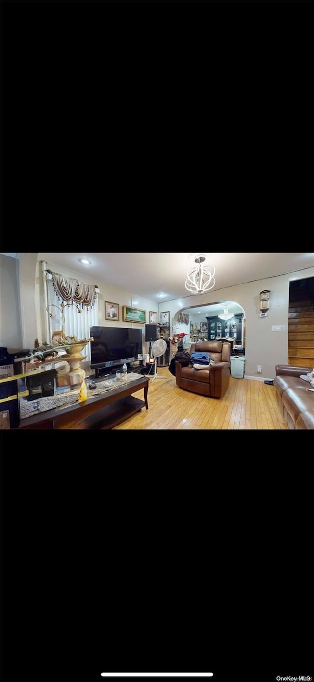 interior space featuring a notable chandelier and hardwood / wood-style flooring