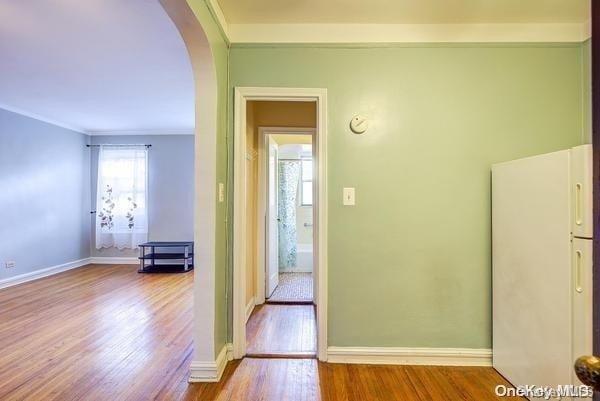 hall featuring ornamental molding and light wood-type flooring