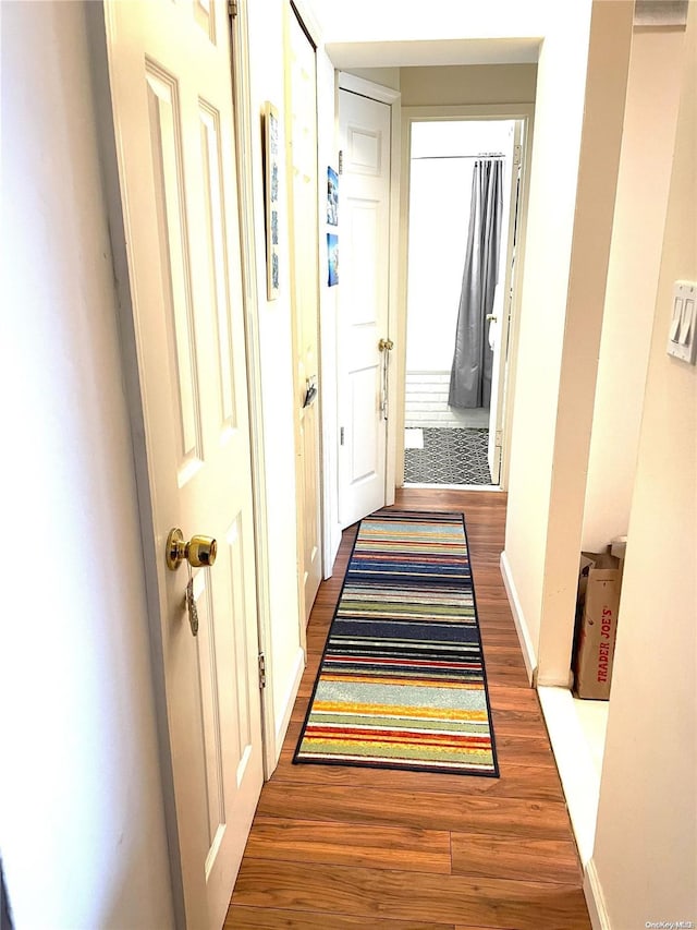 hallway with dark wood-type flooring