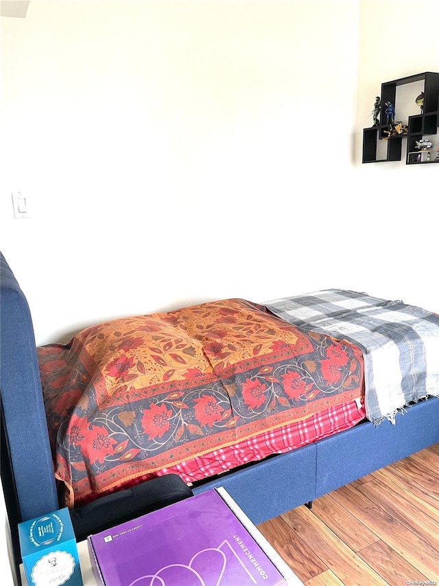 bedroom with hardwood / wood-style floors