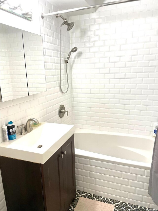 119-49 Union Tpke Unit 7E, Forest Hills, NY 11375 - bathroom with tile walls, vanity, tiled shower / bath combo, and tasteful backsplash