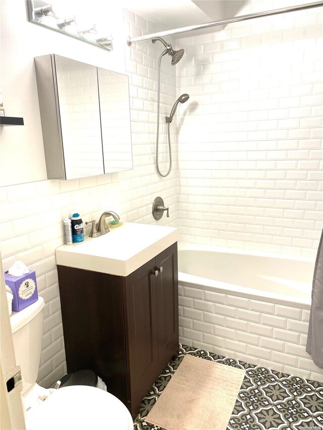119-49 Union Tpke Unit 7E, Forest Hills, NY 11375 - bathroom featuring toilet, tile walls, tiled shower / bath, vanity, and tile patterned floors
