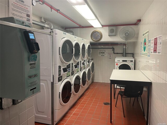 119-49 Union Tpke Unit 7E, Forest Hills, NY 11375 - shared laundry with stacked washer and clothes dryer, washing machine and dryer, tile patterned floors, and tile walls