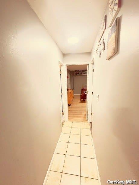 corridor with light tile patterned floors