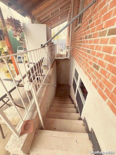 stairs featuring vaulted ceiling