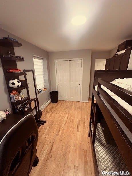 bedroom featuring light wood-type flooring and a closet