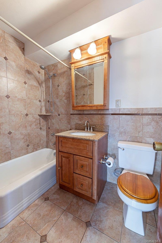 full bathroom featuring vanity, tiled shower / bath combo, tile walls, tile patterned flooring, and toilet