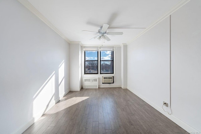 empty room featuring wood-type flooring, ornamental molding, radiator, and a wall mounted AC