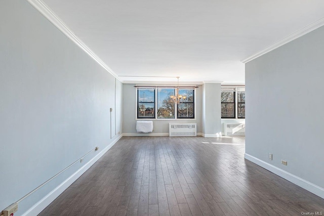 unfurnished room with a notable chandelier, dark hardwood / wood-style floors, radiator heating unit, and ornamental molding