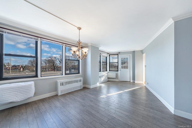 unfurnished room featuring a chandelier, ornamental molding, radiator, and dark wood-type flooring