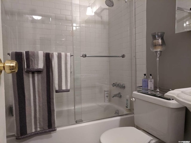 bathroom featuring shower / bath combination with glass door and toilet