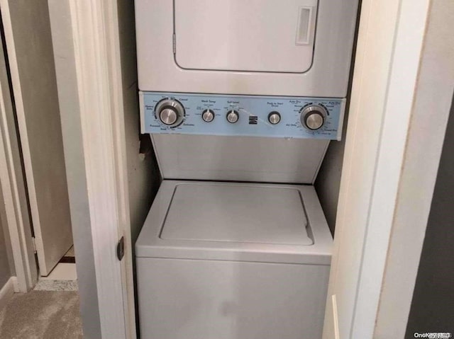 laundry room with stacked washing maching and dryer