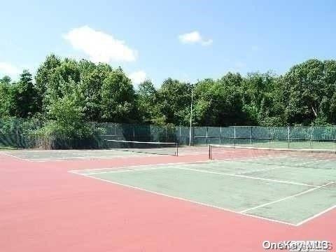 view of sport court with basketball hoop