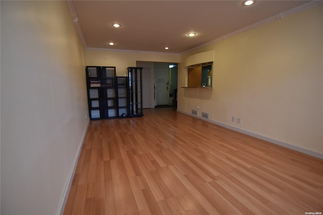 unfurnished room with light hardwood / wood-style floors and ornamental molding