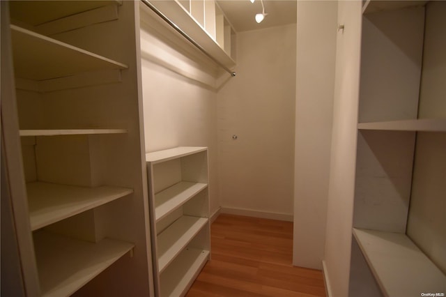 spacious closet with light hardwood / wood-style floors