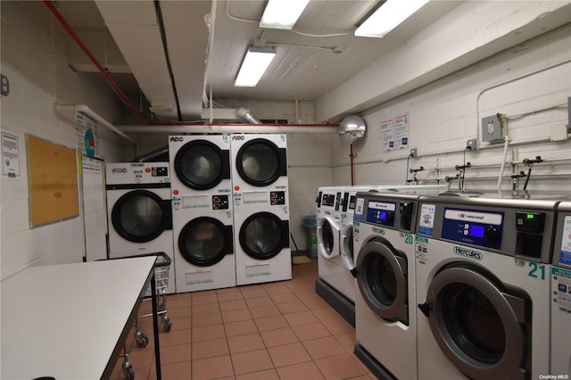 laundry room featuring stacked washer / dryer and washing machine and clothes dryer