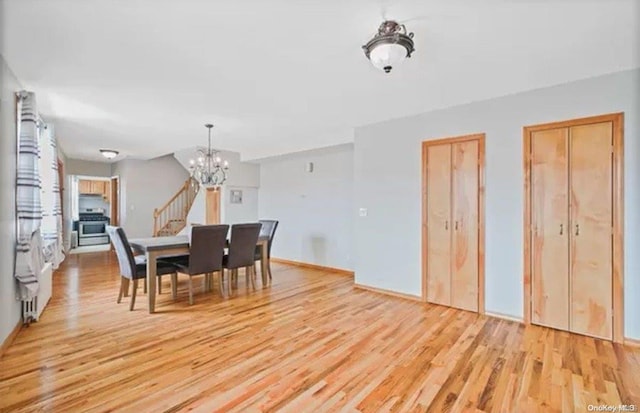 dining room with a notable chandelier and light hardwood / wood-style flooring