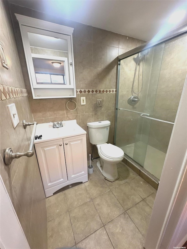 bathroom with tile patterned flooring, an enclosed shower, tile walls, and toilet