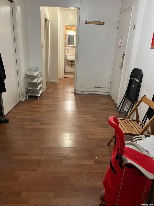 hallway with sink and dark wood-type flooring