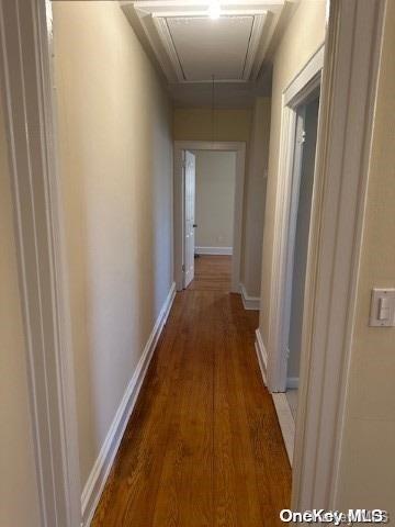 hallway with dark wood-type flooring