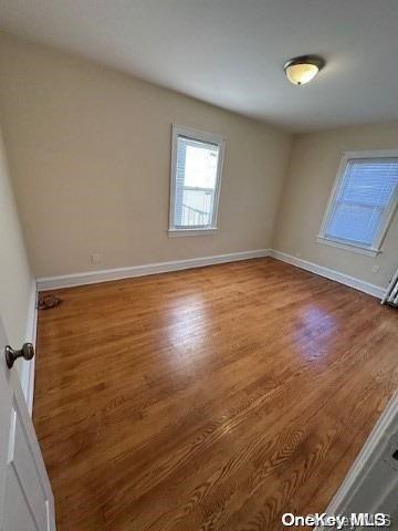 spare room with hardwood / wood-style flooring