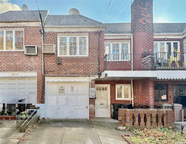 back of house featuring a balcony and an AC wall unit