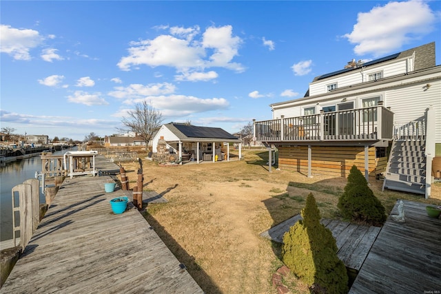 view of yard with a deck with water view