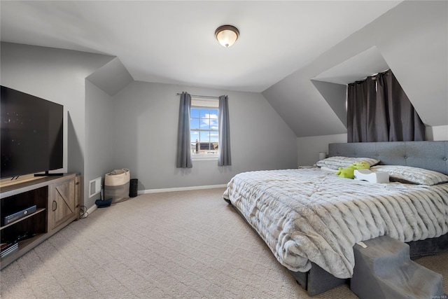 carpeted bedroom with lofted ceiling