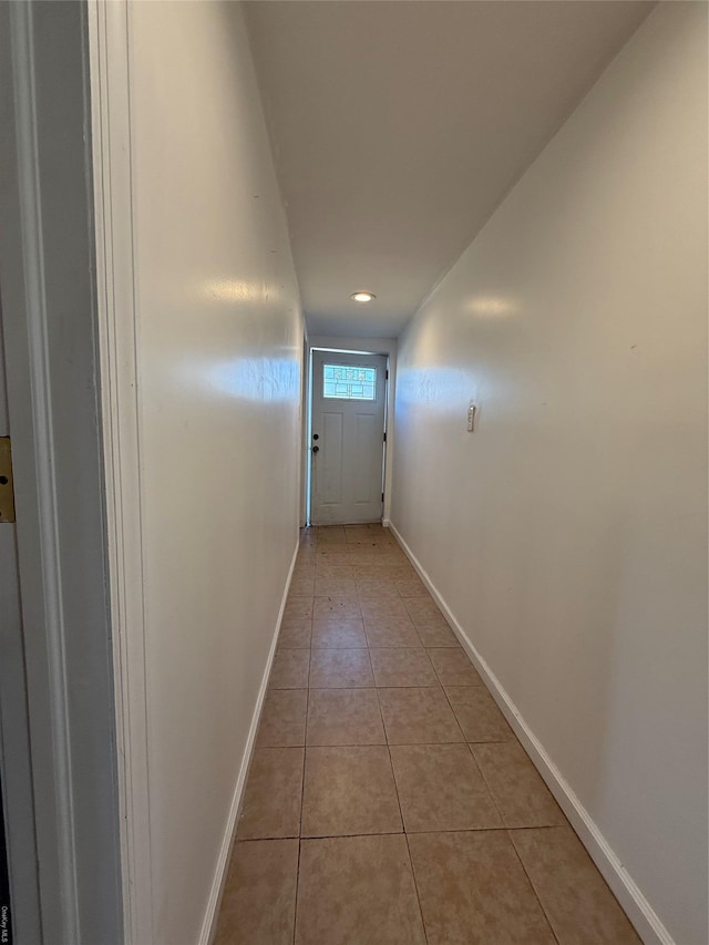 doorway featuring light tile patterned flooring