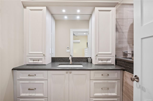 bathroom with ceiling fan and vanity