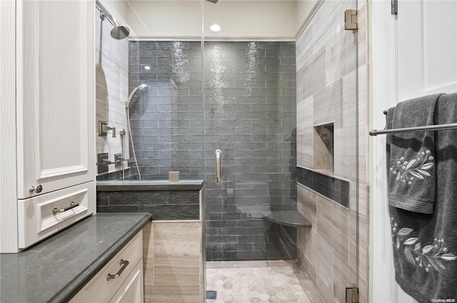 bathroom with tile patterned floors and an enclosed shower