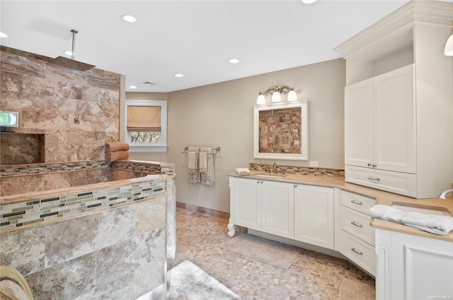 bathroom with a bathing tub and vanity